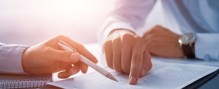 Business people negotiating a contract.