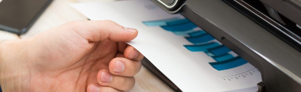 Man's hand making copies. Working with printer