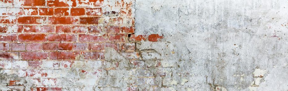 Vintage brick rough rustic wall with cracked plaster. Grunge Red white stonewall background.