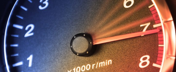 Arrow of tachometre in red zone. Car dashboard. Accelerating.