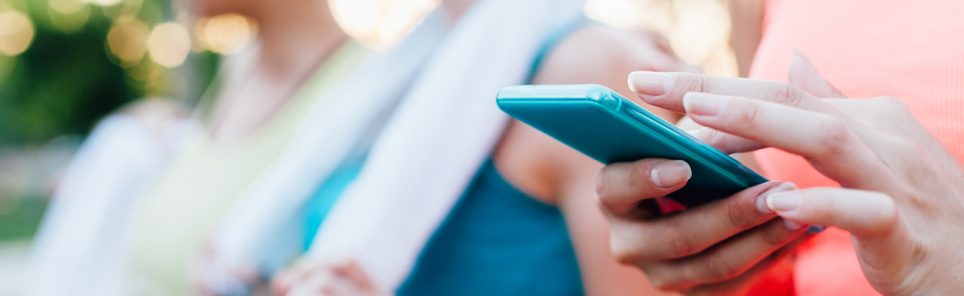 Sports woman checking fitness result on mobile phone