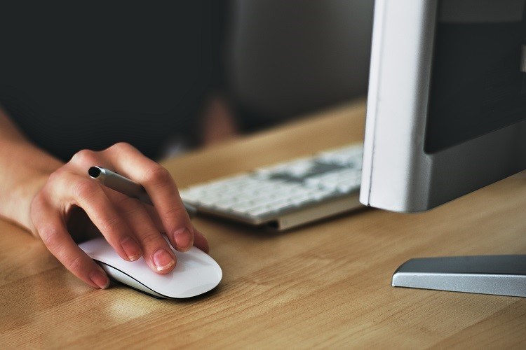 someone holding a computer mouse