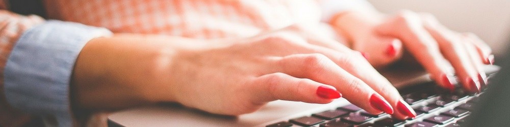hands typing on laptop