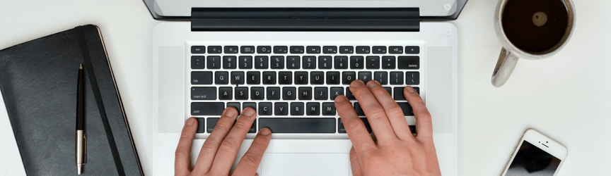 image of hands on a laptop keyboard