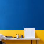 Person sitting at a desk facing the wall