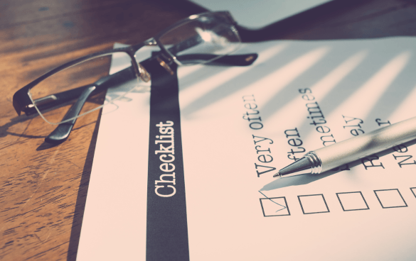 Eyeglasses and a pen on a checklist with frequency options ranging from 'Very often' to 'Never' on a wooden surface.