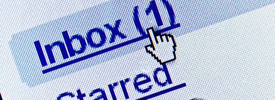 Close-up of a computer screen with an email inbox interface showing one unread email and a cursor icon clicking on the 'Inbox' link.