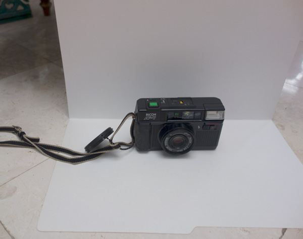 Camera on top of a white folder