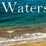 A serene beach scene with gentle waves washing onto the sandy shore under the word 'Waterscapes'.