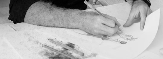 Close-up of a person's hands sketching a human figure on paper with a pencil, with smudges of graphite or charcoal on the side.