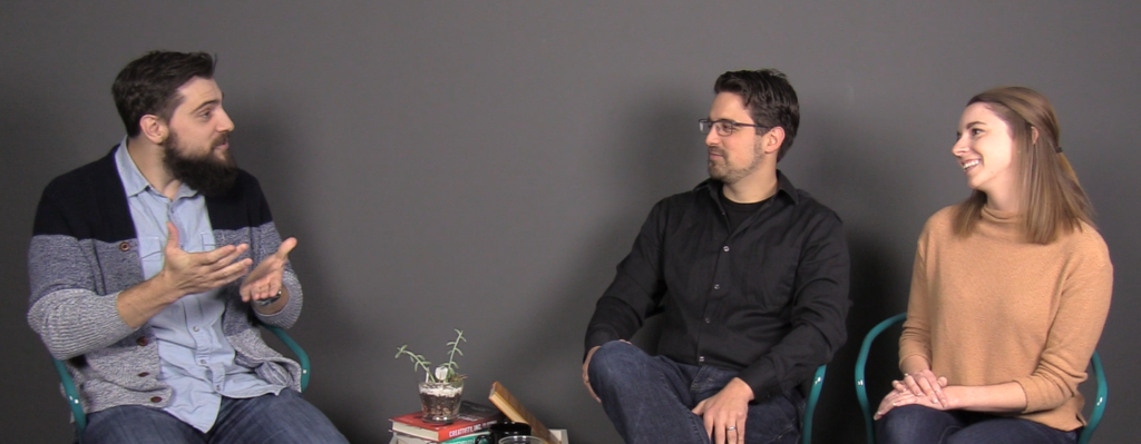 Three WebFX team members sit in chairs having a discussion