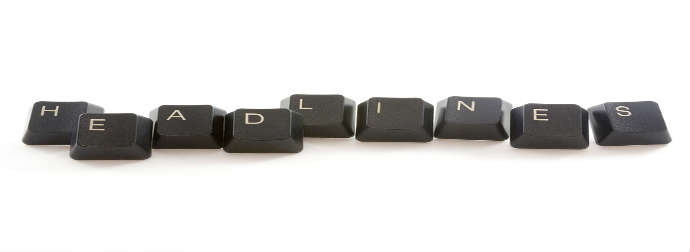 Keyboard keys arranged to spell 'HEADLINES' on a white background.