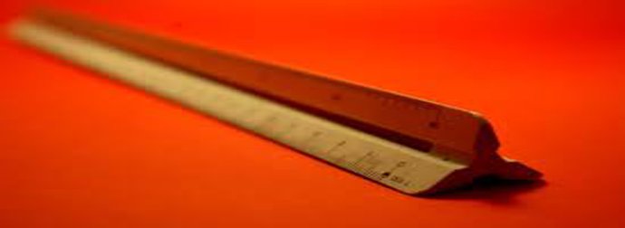 A metal ruler with a bent tip on a red surface, positioned diagonally.