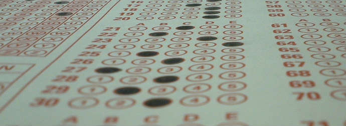 Close-up of a filled-in standardized multiple-choice test answer sheet with selected answers marked in black.