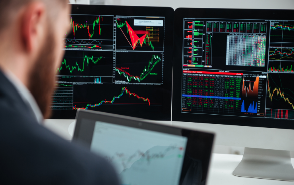 Man looking at analytics on computers