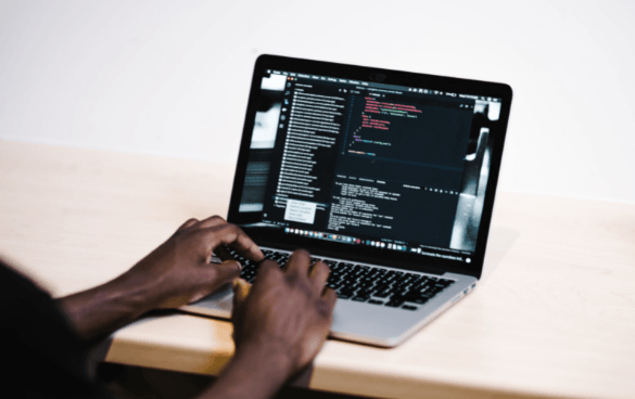 Man coding a website on a laptop