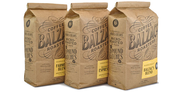 Three brown paper coffee bags from Ballz Roasters, featuring Farmers Blend, Espresso, and Ballzac Blend, with vintage-style labels.