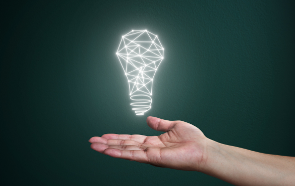 An open hand with a geometric wireframe light bulb illustration floating above it against a dark green background.