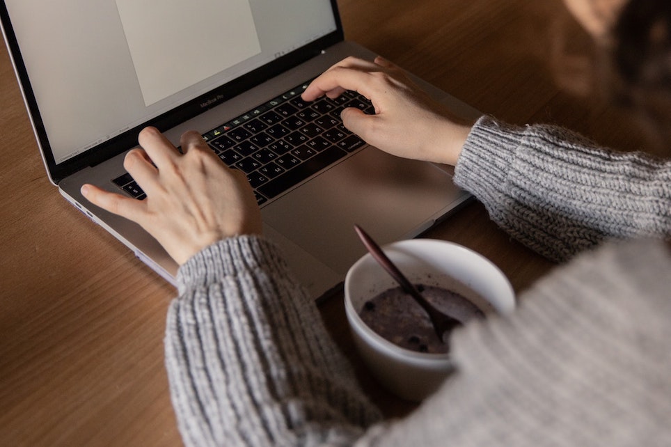 Businesswoman Using Laptop During Meal