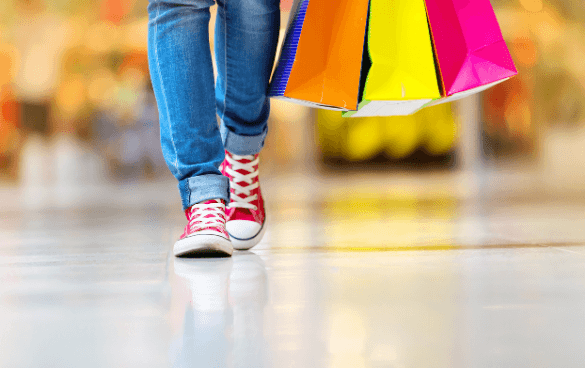 Person carrying shopping bags in a mall