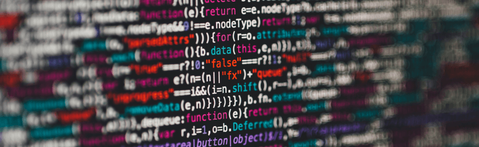 Blurred lines of colorful computer code on a screen with visible elements of programming syntax.