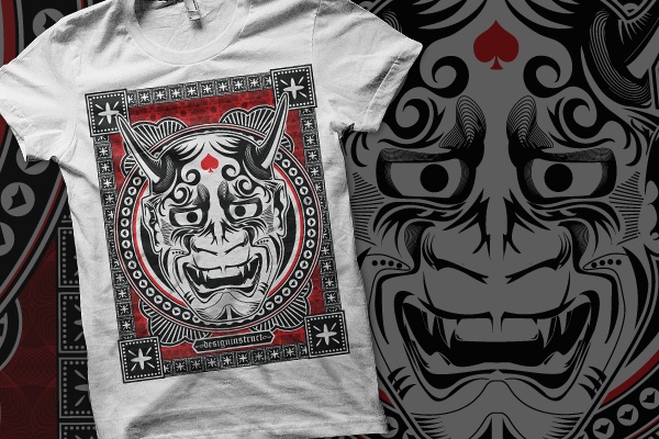 A white t-shirt with a graphic print of a playing card design featuring a stylized demon-like figure with horns and a fierce expression, surrounded by a decorative border with stars and other symbols.