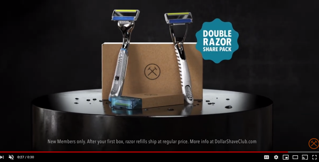 Two razors with blue and green blades next to a 'DOUBLE RAZOR SHARE PACK' box on a reflective surface, with promotional text for new members of a razor subscription service.