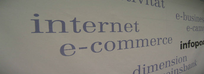 Close-up of printed words 'internet' and 'e-commerce' in bold font, with other partially visible technology-related terms.