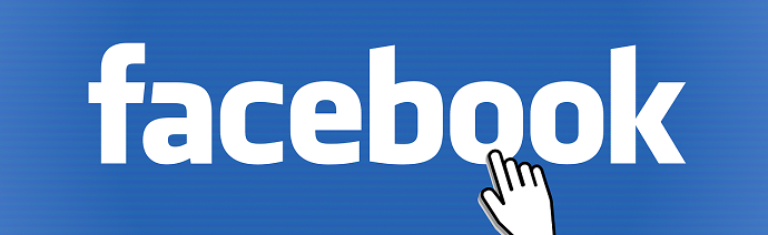 The Facebook logo with a hand cursor pointing to it.