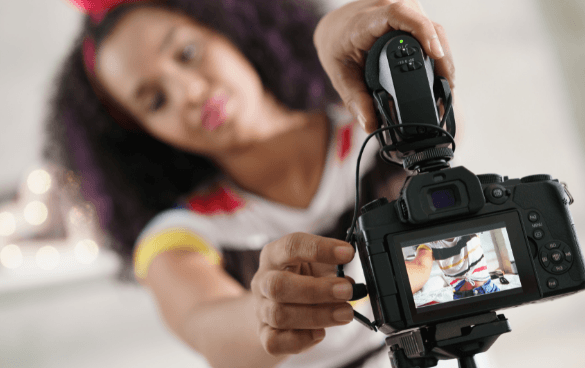 A woman adjusts a camera