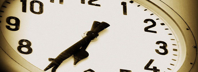 Close-up of a vintage clock face showing the time at ten minutes past ten with sepia toning.