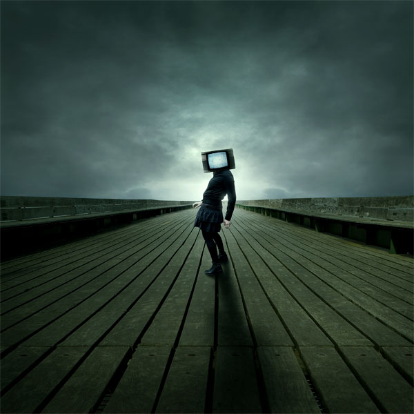 A person with a television set for a head stands on a wooden pier under a stormy sky, creating a surreal scene.