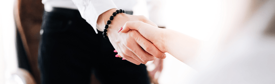 A person shakes hands after finding leads