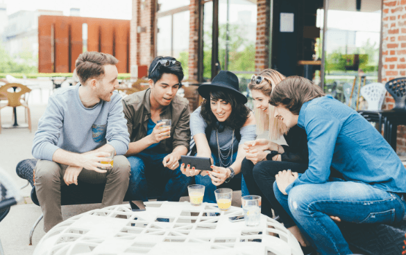 People sitting in a group looking at a phone