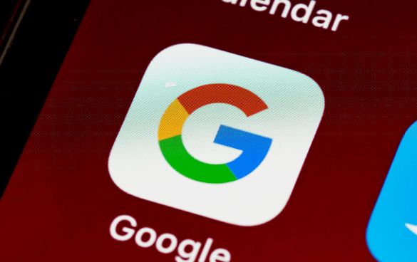 Close-up of the Google app icon on a smartphone screen with part of the Calendar app visible above it.