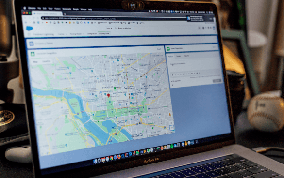 A laptop screen displaying a map of Washington, D.C. on a web browser with multiple tabs open.