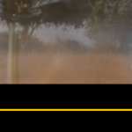 YouTube video player paused on an advertisement with a dust cloud or mist, a countdown timer showing 7 seconds left, video controls, and a 'Skip Ad' button.