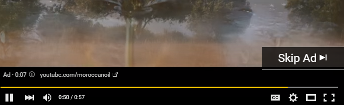 YouTube video player paused on an advertisement with a dust cloud or mist, a countdown timer showing 7 seconds left, video controls, and a 'Skip Ad' button.