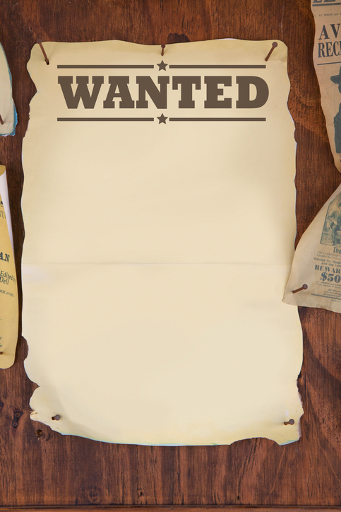 wanted notice paper on old wooden background