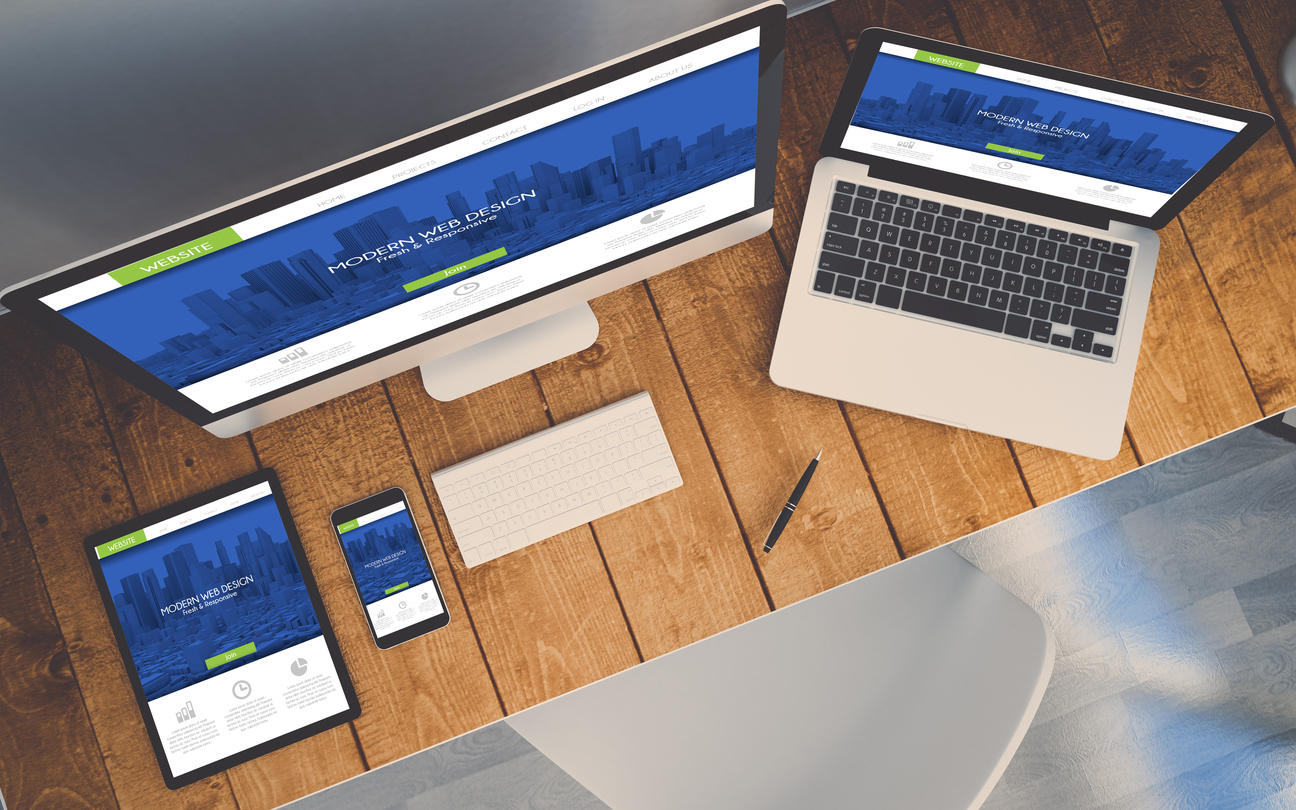top view of a computer, laptop, smartphone and tablet on a desktop workspace. responsive website on screen. 3d rendering. All screen graphics are made up.