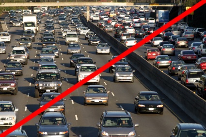 Heavy traffic jam on a multi-lane highway with numerous cars closely packed together, and a red diagonal line across the image.