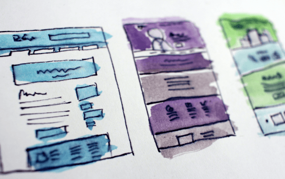 Hand-drawn sketches of website or app layouts using blue, purple, and green watercolors, representing design mock-ups or wireframes.