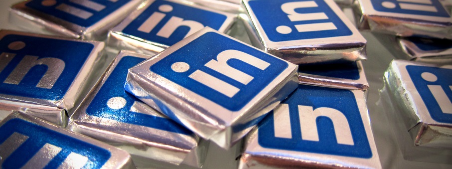 A collection of LinkedIn logo pins with a metallic finish.