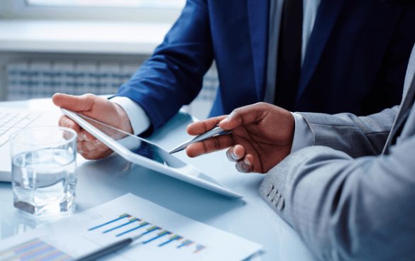 Two businessmen looking at information on a piece of paper