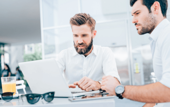 Two men browsing on a computer