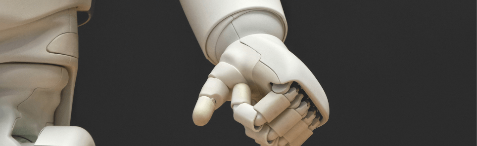 Close-up of two white humanoid robotic hands with visible joints about to touch fingertips.