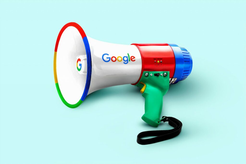 A megaphone with Google's logo and brand colors on a light blue background.