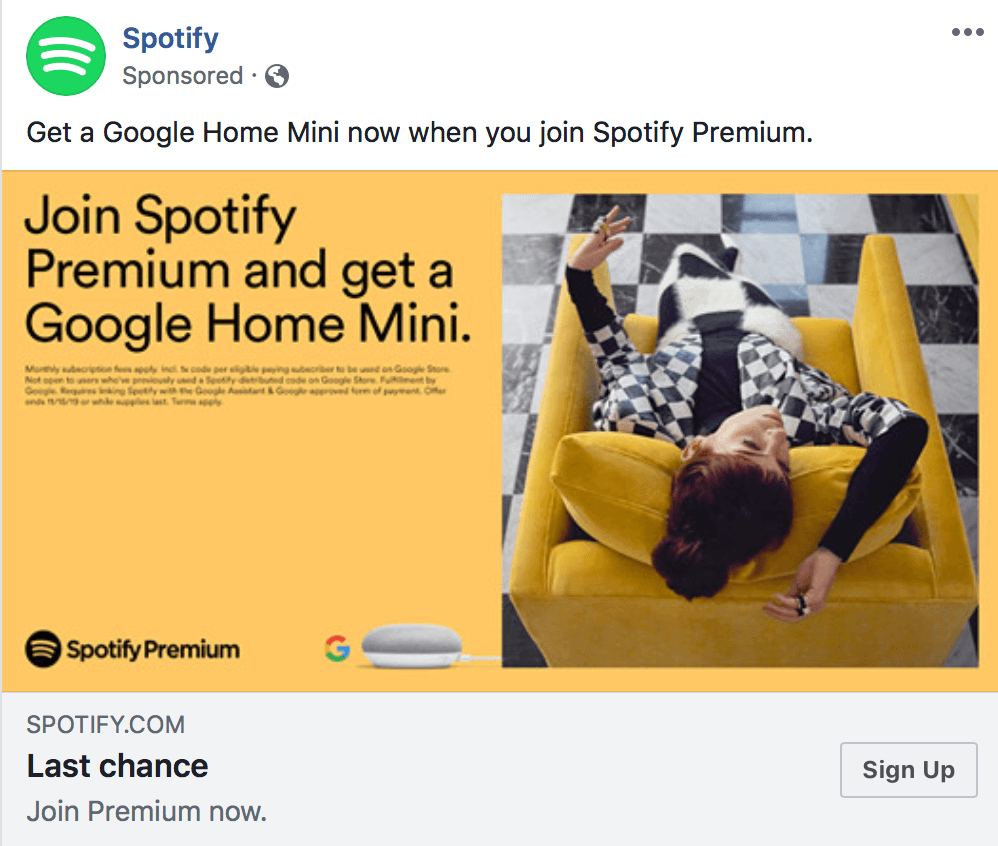 Advertisement from Spotify featuring a person lounging upside down on a yellow armchair with headphones on, next to the text 'Join Spotify Premium and get a Google Home Mini.' Below the image is the Spotify logo, Google logo, and a 'Sign Up' button.