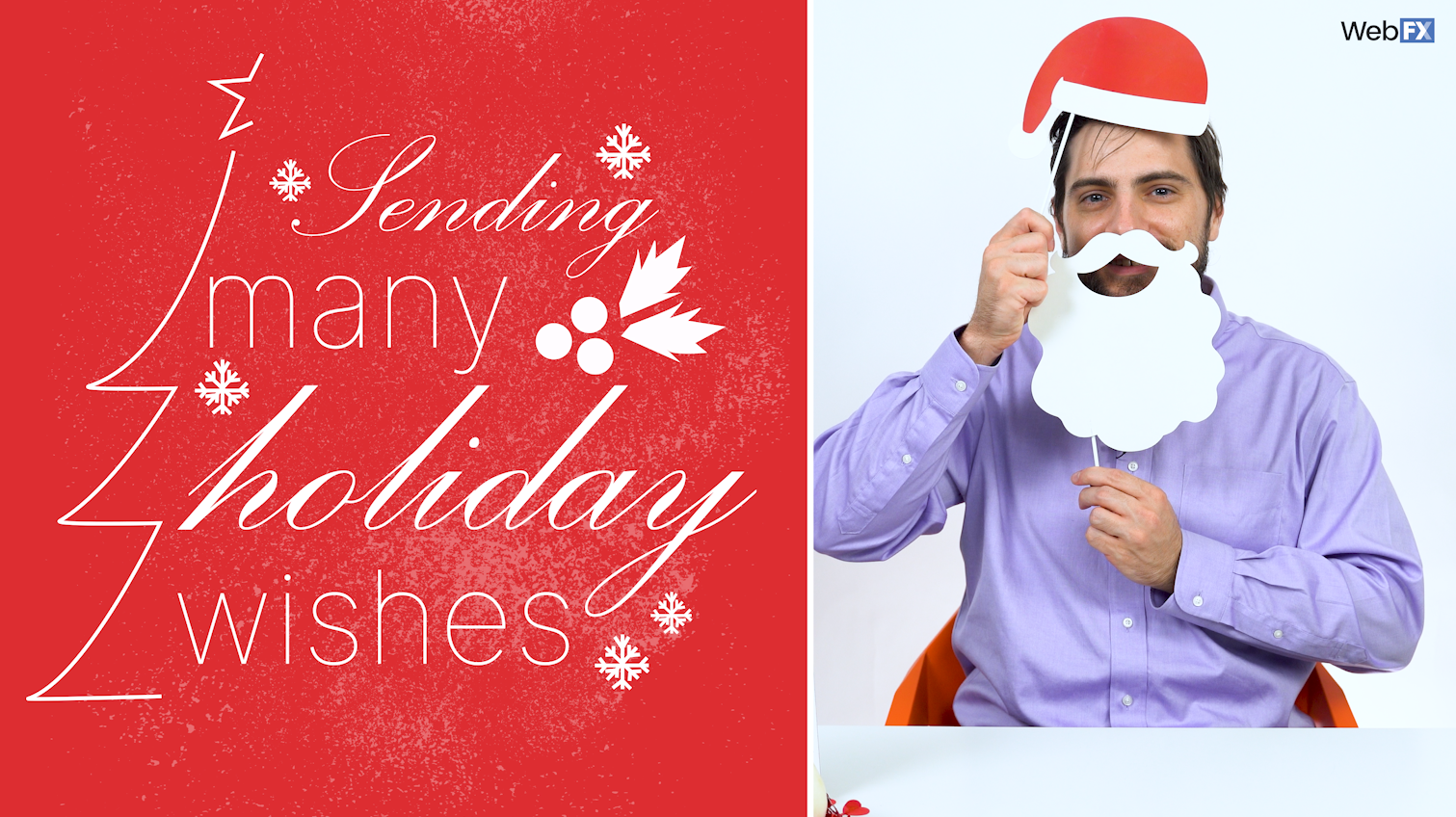 A man holds photo props resembling Santa Claus