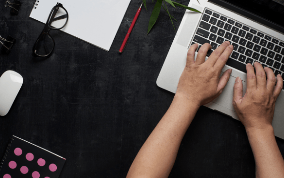 Person typing on a Mac laptop